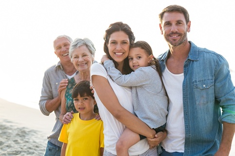 Happy family posing at the beach